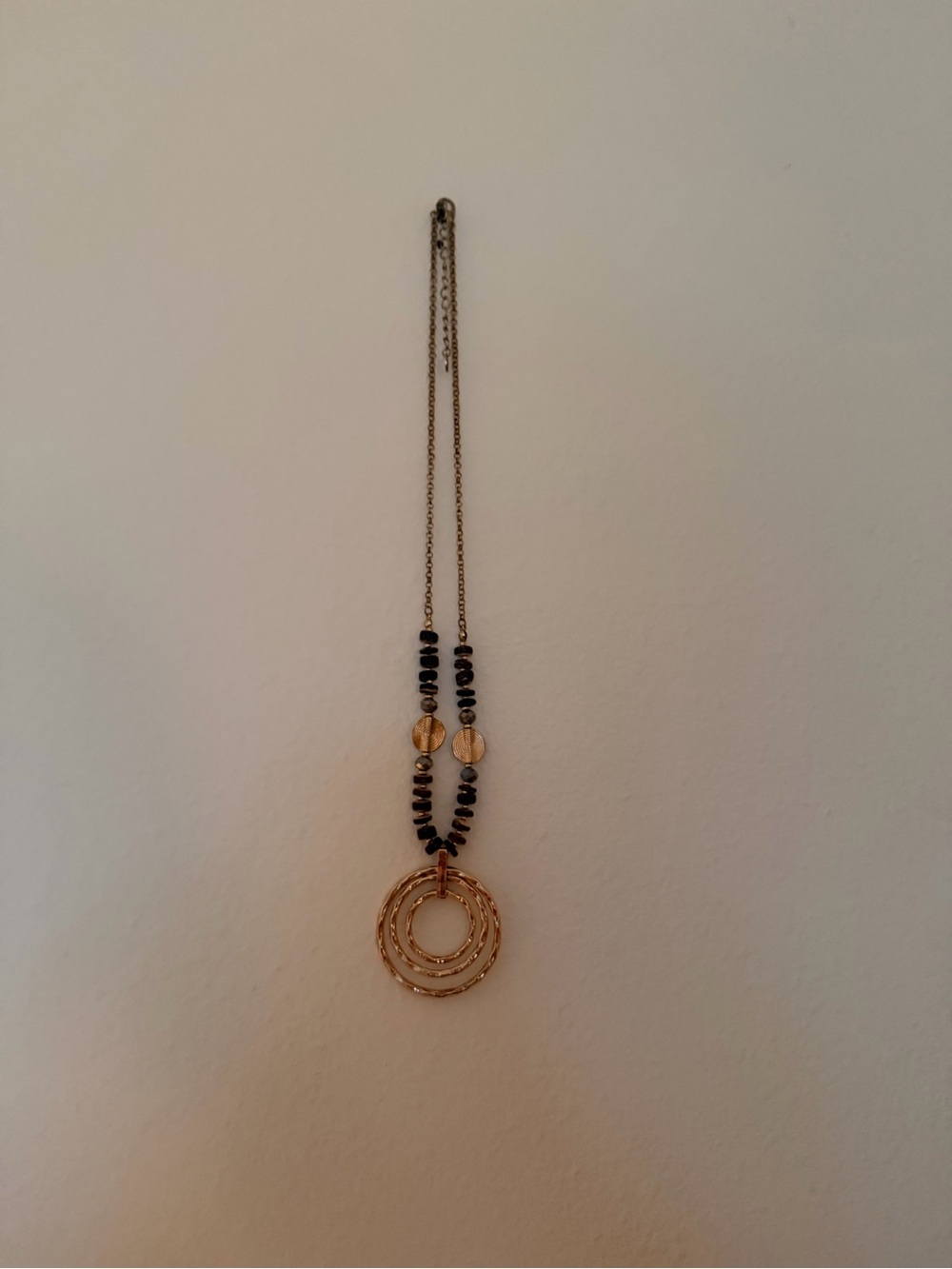 Gold Multi-Ring Pendant Necklace with Black Bead Accents